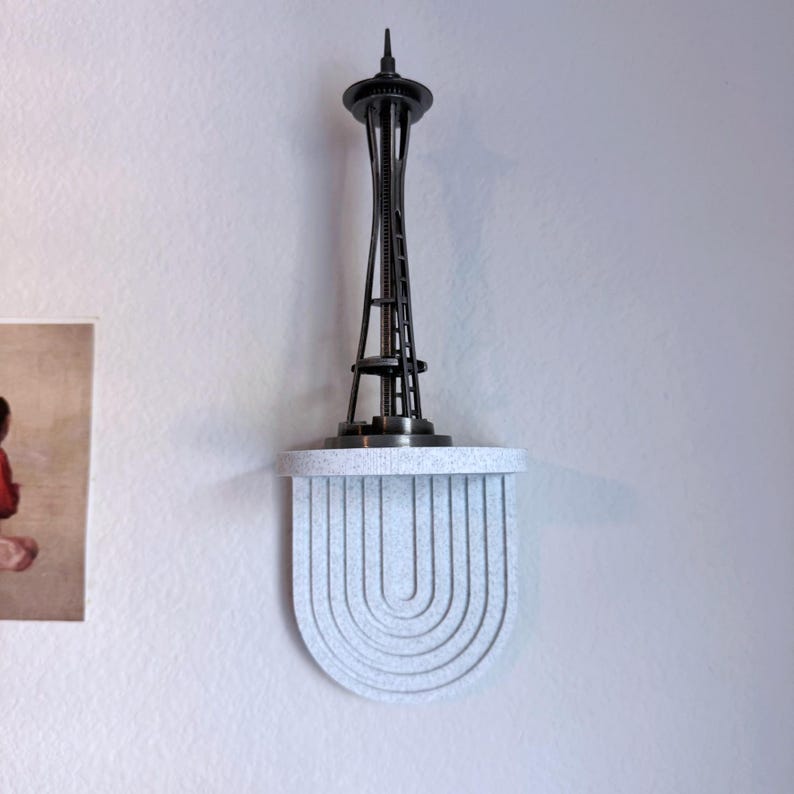 a set of mini wall hanging shelves with a modern ribbed arched design, shown in a variety of colors. The shelves hold small items.