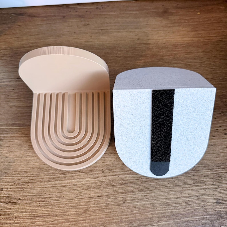 a set of mini wall hanging shelves with a modern ribbed arched design, shown in a variety of colors. The shelves hold small items, and hand on the wall with wall strips.