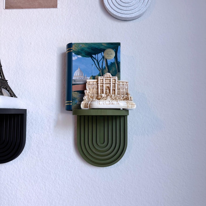 a set of mini wall hanging shelves with a modern ribbed arched design, shown in a variety of colors. The shelves hold small items.