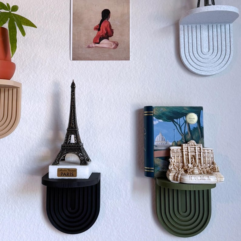 a set of mini wall hanging shelves with a modern ribbed arched design, shown in a variety of colors. The shelves hold small items.