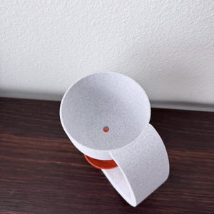 May include: White ceramic planter with a drainage hole in the bottom. The planter is attached to a white ceramic ring.