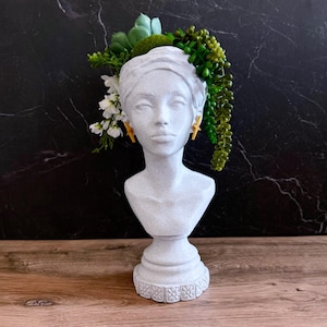 Busto de cabeza femenina, jarrón de flores secas y artificiales