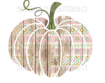May include: A white pumpkin with a pink, blue, and gold geometric pattern on a woodgrain background. The pumpkin has a green stem.