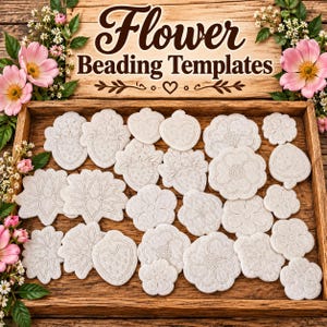 May include: A collection of white felt flower and strawberry beading templates arranged in a wooden tray. The wooden sign above reads Flower Beading Templates. The templates feature various floral and fruit outlines for embroidery or beadwork.