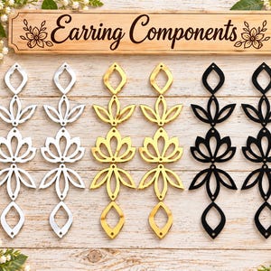 May include: Six vertical earring components arranged in pairs of silver, gold, and black. Each piece features a repeating geometric floral pattern with small circular holes for assembly. A wooden sign at the top reads Earring Components.