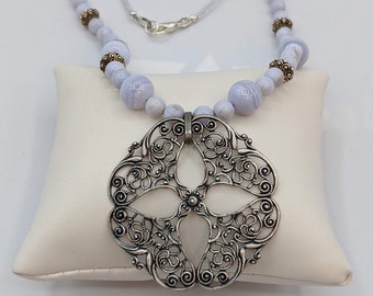 Blue Lace Semi Precious Beads with an antique metal pendent.  Has Silver accents.