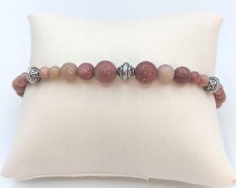 This beautiful semi precious Rhodonite Bracelet has pewter pacer beads.