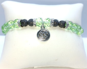 Irish knot charm with glass and volcanic lava rock beads. Stunning.