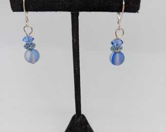 This blue and white two toned bead is accented by a pewter spacer bead and a bright blue crystal.