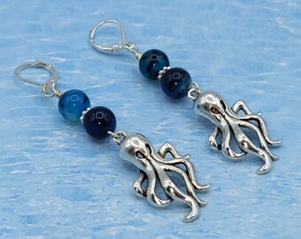 Cute pewter octopus earrings with blue/black glass beads and sterling silver leverback.