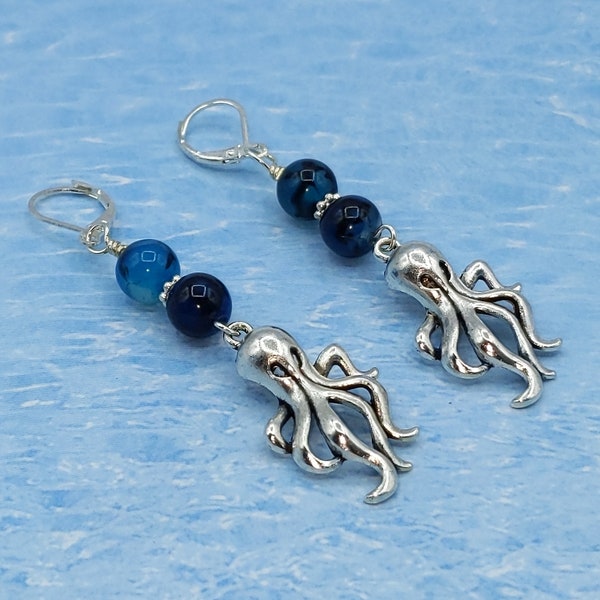 Cute pewter octopus earrings with blue/black glass beads and sterling silver leverback.