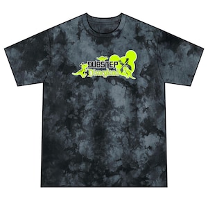 May include: A short-sleeve t-shirt with a black and gray tie-dye pattern. The chest features a lime green graphic with the text "DUBSTEP Disneyland" accompanied by small dinosaur illustrations and a stylized mouse ear silhouette shape.