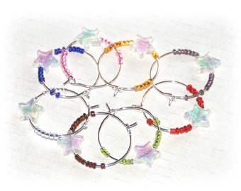 10 SET STARDUST PERLEN SEKTGLAS ANHÄNGER GLASMARKIERER PARTY DEKO BUNT RING 10 SET STARDUST PERLEN SEKTGLAS ANHÄNGER GLASMARKIERER PARTY DEKO BUNT RING