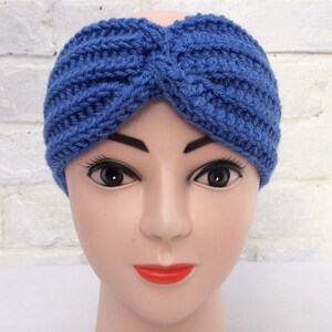 May include: A blue knitted headband with a twisted design. The headband is made of a soft, stretchy yarn and is perfect for keeping your ears warm in the winter.