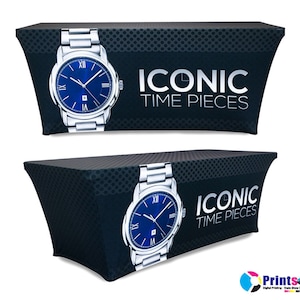 May include: Black and white table cover with a silver watch and the text "Iconic Time Pieces".