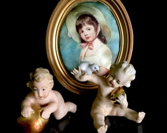 grafenthal German porcelain antique pair of Cupid cherubs with heart, ball , arrow in 24 kt gold details