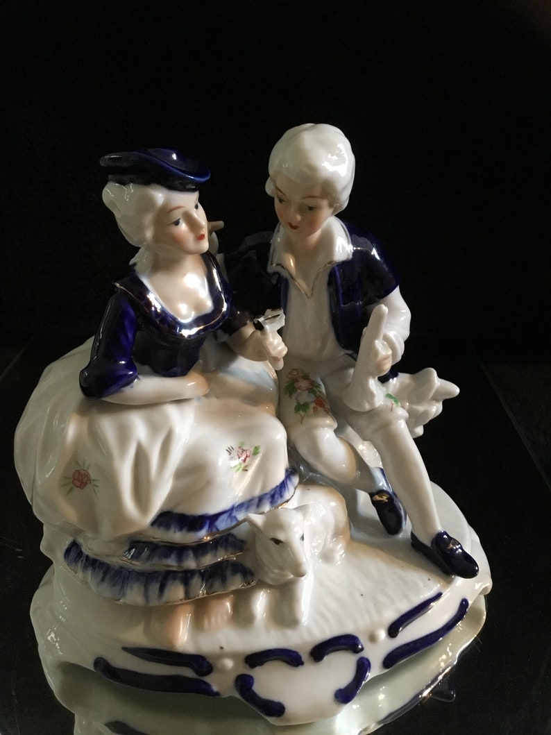 Vintage porcelain figurine in cobalt blue romantic couple