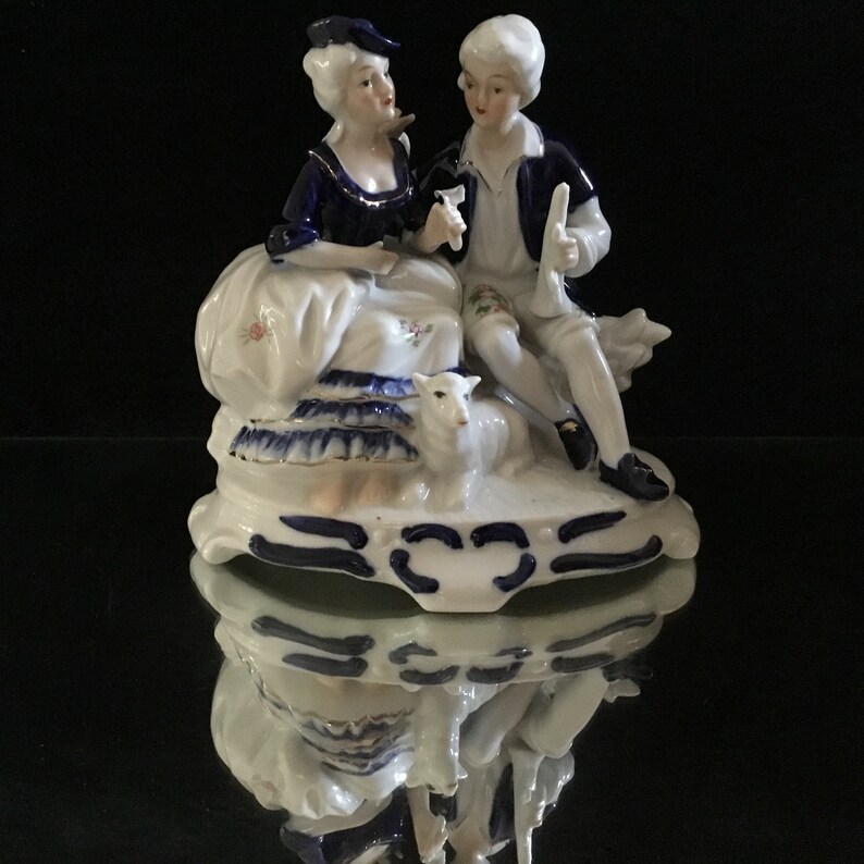 Vintage porcelain figurine in cobalt blue romantic couple