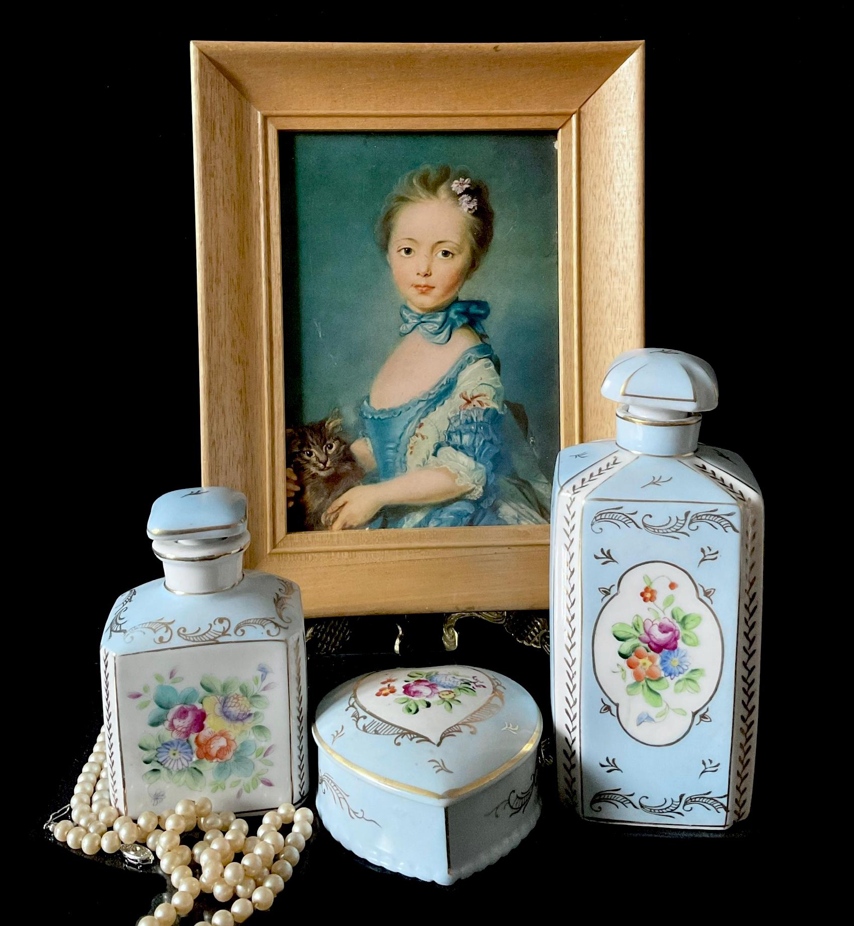 Parisienne porcelaine set blue perfume bottles with flowers and golden details.