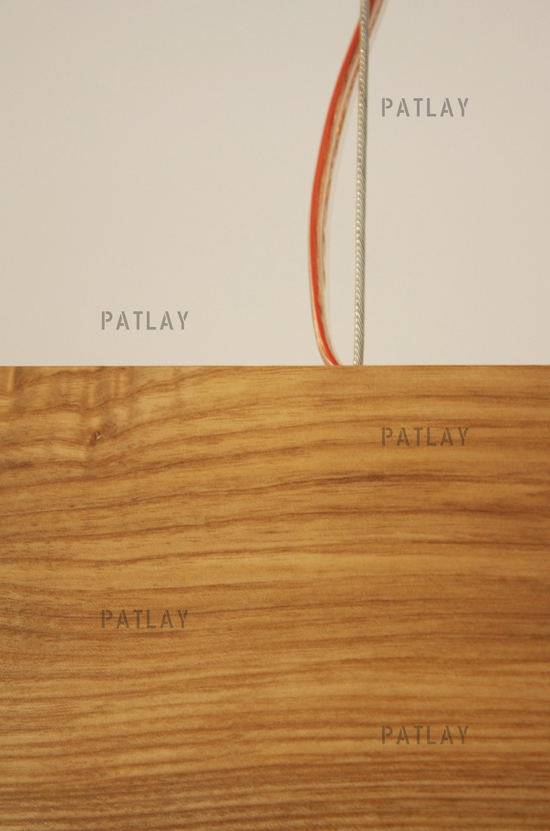 May include: Close-up of a woodgrain surface with the word "PATLAY" printed five times in a light gray color.
