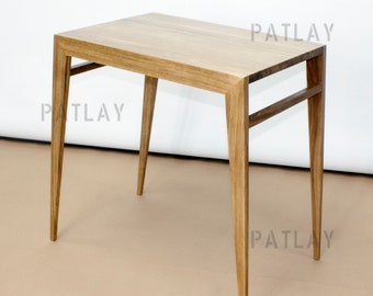 May include: A wooden side table with a rectangular top and four legs. The table has a simple, modern design.
