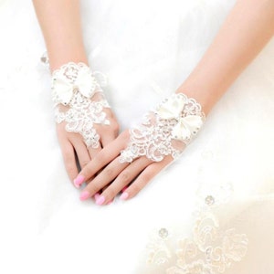 Pair of Short White Fingerless Lace Bridal Gloves With Wrist Bow & Diamonte Detail image 2