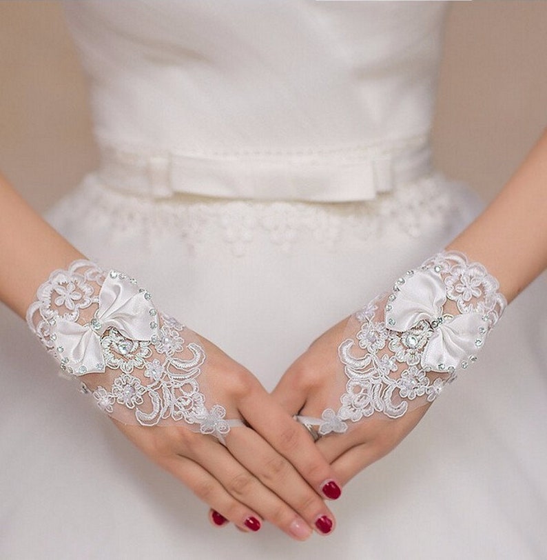 Pair of Short White Fingerless Lace Bridal Gloves With Wrist Bow & Diamonte Detail image 1