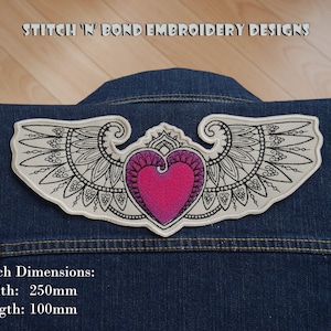 May include: A white embroidered patch featuring a pink heart and black wings. The patch measures 250mm wide and 100mm long. "Stitch 'N' Bond Embroidery Designs" is printed at the top of the image.