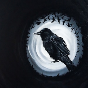 May include: A black crow with a white circle behind it. The crow is perched on a branch with its wings spread out. There are many smaller black birds flying around the crow.
