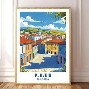 May include: A framed art print featuring a vibrant illustration of Plovdiv, Bulgaria. The artwork depicts a sunny cityscape with colorful buildings, red rooftops, and a blue sky with fluffy clouds. The text "PLOVIV" and "BULGARIA" are at the bottom.