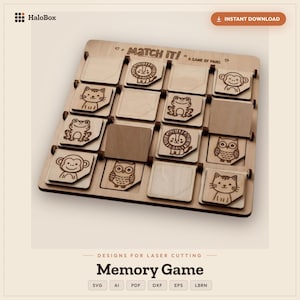 Peut inclure: Un jeu de mémoire en bois composé d'une grille de tuiles carrées avec des illustrations d'animaux gravées au laser, notamment un lion, un singe, un chat, une grenouille et un hibou. Le plateau porte l'inscription "MATCH IT! A GAME OF PAIRS".