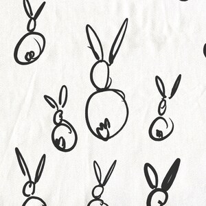 May include: A white background with black line drawings of rabbits. The rabbits are drawn in a simple, childlike style.