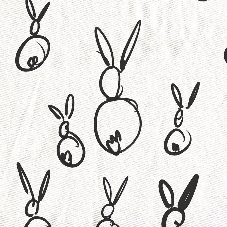 May include: A white background with black line drawings of rabbits. The rabbits are drawn in a simple, childlike style.