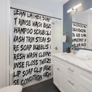 May include: A white shower curtain with black text that reads "LEAN LATHER SOAP", "TRINSE WASH BRUS", "HAMPOO SCRUBCL", "VASH TRIM STEAN SH", "RE SOAP BUBBLES", "RESH WASH CLEANS", "INSE FLOSS TWEEZE", "LIP SOAP CLIP BRUS", "SE CONDITION SUDS".