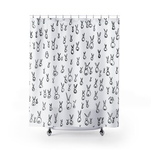 May include: White shower curtain with a black and white repeating pattern of bunnies.
