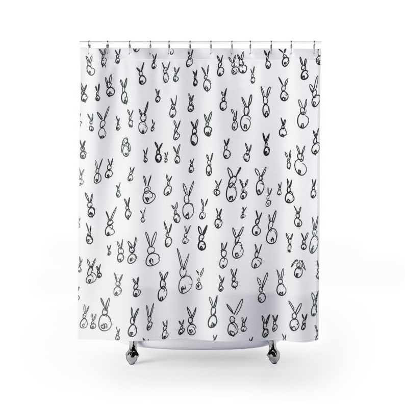 May include: White shower curtain with a black and white repeating pattern of bunnies.