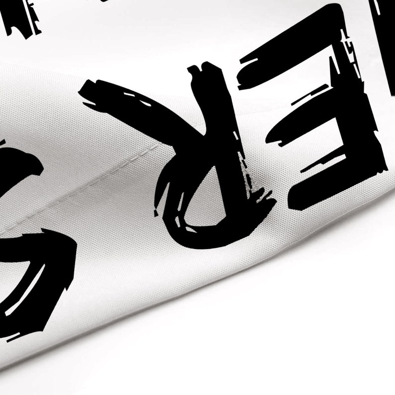 May include: Black and white graphic text on a white fabric background. The text reads "FREE".