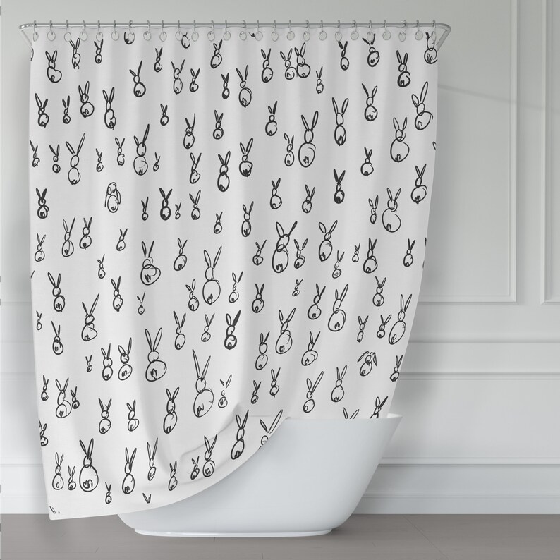 May include: White shower curtain with a black and white bunny rabbit pattern. The bunnies are drawn in a simple, minimalist style.