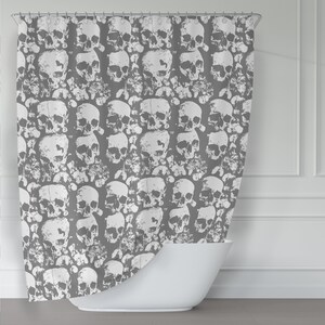 May include: Grey shower curtain featuring a white skull pattern. The skulls are arranged in a repeating pattern and are slightly faded, giving the design a vintage look.