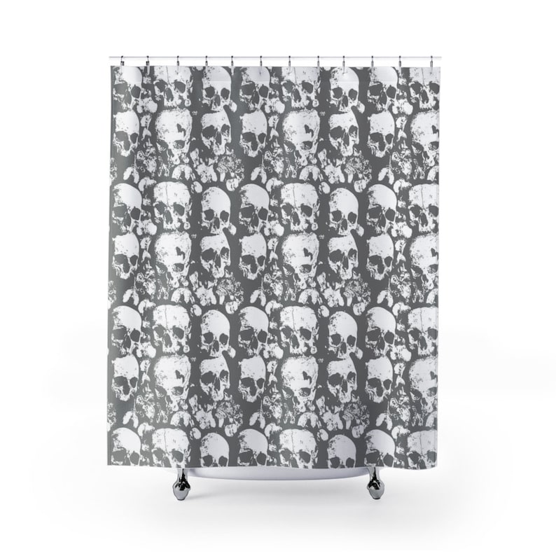 May include: A grey shower curtain with a white skull and crossbones pattern.