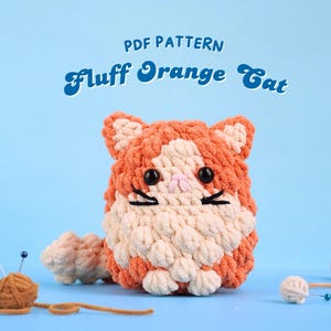 May include: PDF pattern for crocheting a fluffy orange cat. The cat is made with white and orange yarn and has black eyes and whiskers.
