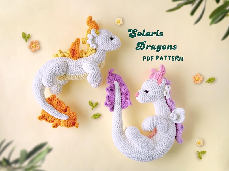 May include: Two crocheted dragon amigurumi toys. One is orange and yellow, the other is purple. Both are white with black eyes. The text "Solaris Dragons PDF PATTERN" is above the toys.