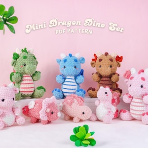 May include: A selection of handmade crochet mini dragon and dinosaur toys in shades of green, blue, brown, and pink. The toys feature striped bellies and are displayed on a white surface. The text "Mini Dragon Dino Set PDF Pattern" is visible.