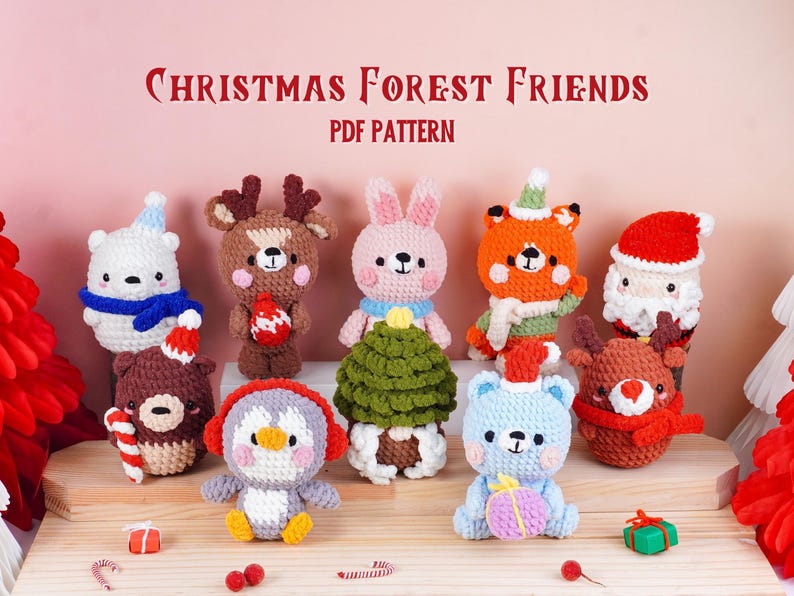 May include: A collection of handmade crochet Christmas ornaments featuring various forest animals, including a bear, deer, fox, rabbit, penguin, and Santa Claus. The ornaments are in festive colors and are displayed on a wooden surface. Text reads "Christmas Forest Friends PDF Pattern."