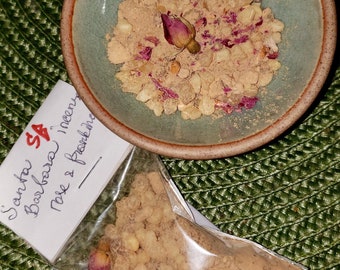 May include: A small bag of brown incense with a label that reads "Santa Barbara Incense Rose & Frankincense". The incense is in a small bowl with a pink rose bud.