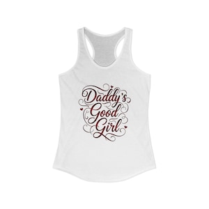 May include: White racerback vest featuring the text "Daddy's Good Girl" in a burgundy script font. The text is surrounded by decorative swirls and small heart accents. The vest has a scoop neck and a racerback design.