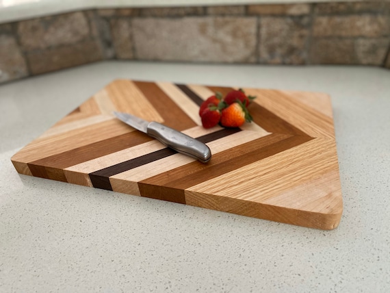 Handmade striped cutting or serving board with hanging feature