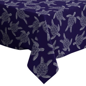 May include: Navy blue tablecloth with a white patterned design of stylized sea turtles.