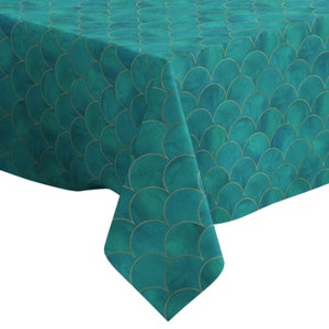 May include: Teal tablecloth with a gold scale pattern. The tablecloth is made of a soft, textured fabric.