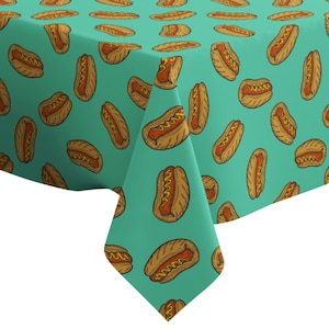 May include: A teal tablecloth with a repeating pattern of hot dogs. The hot dogs are drawn in a cartoon style with mustard and ketchup.